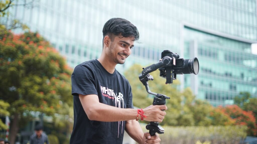Young Indian videographer filming outdoors with a gimbal